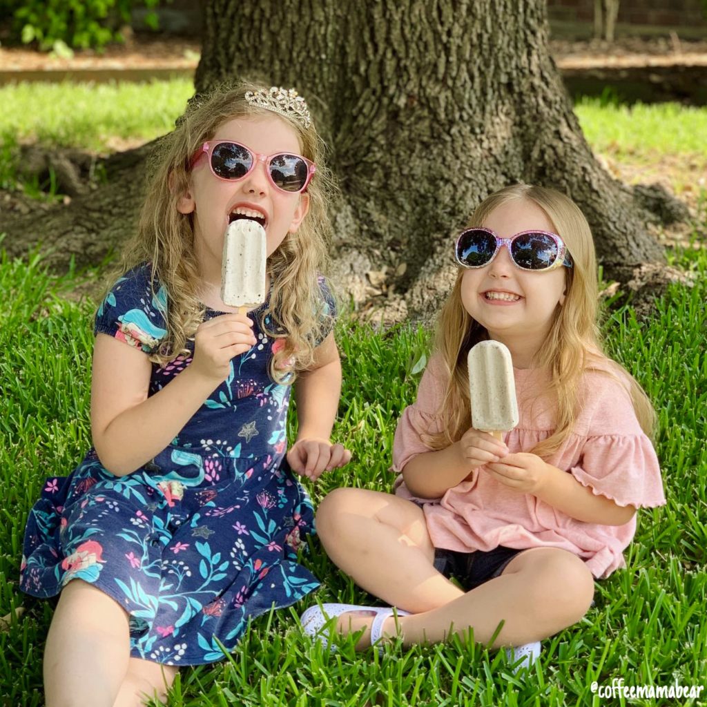 The girls enjoying all things summer with popsicles in the shade.